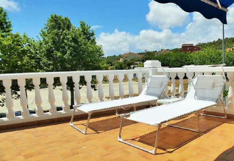 Chaises longues en terrasse pr`s de la piscine